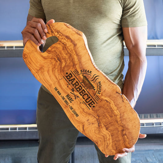 man holding large grill board olive wood