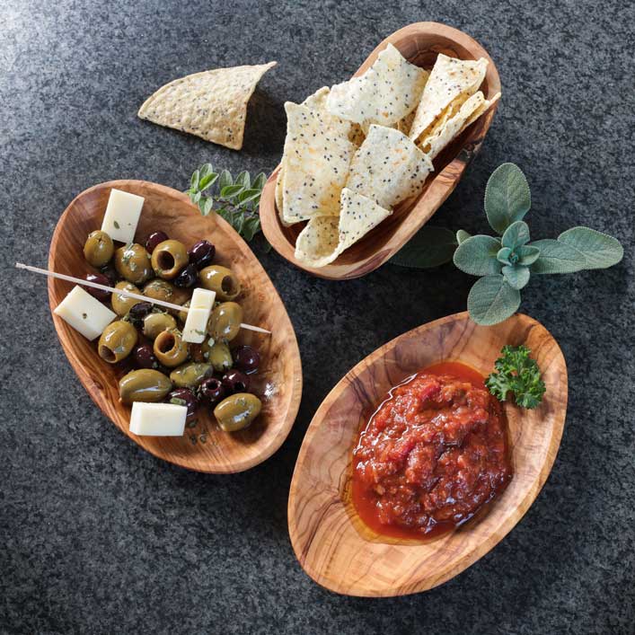 Oval bowl made from olive wood for serving snacks, nuts and salsa