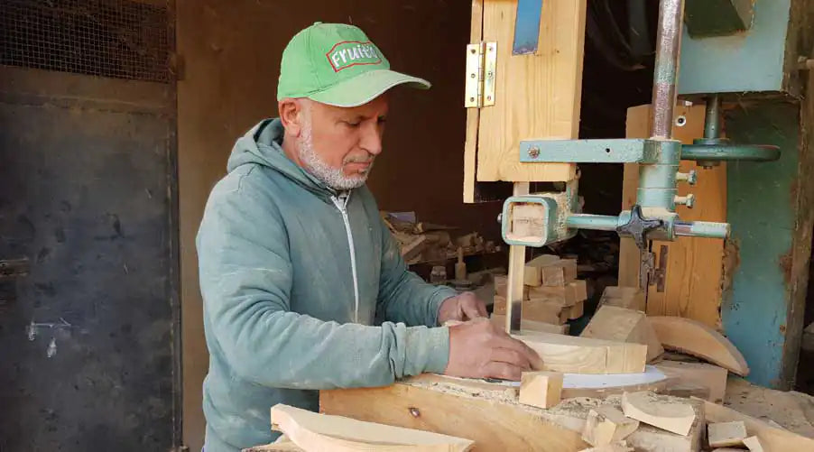 man crafting olive wood tableware for jamailah