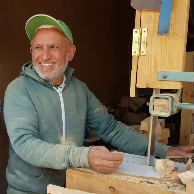 man crafting olive wood tableware for Jamailah