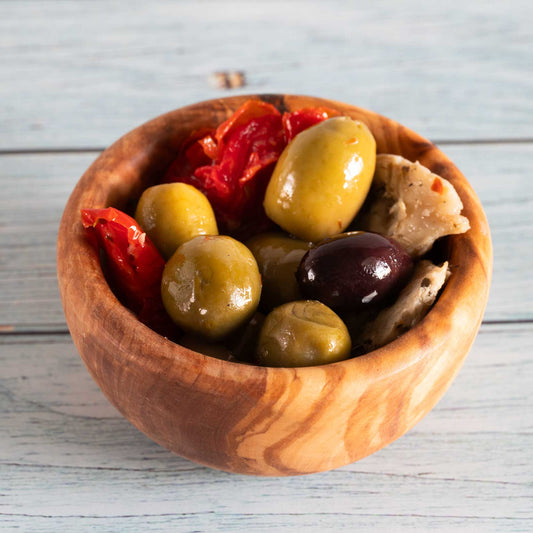 small bowl made from olive wood filled with olives