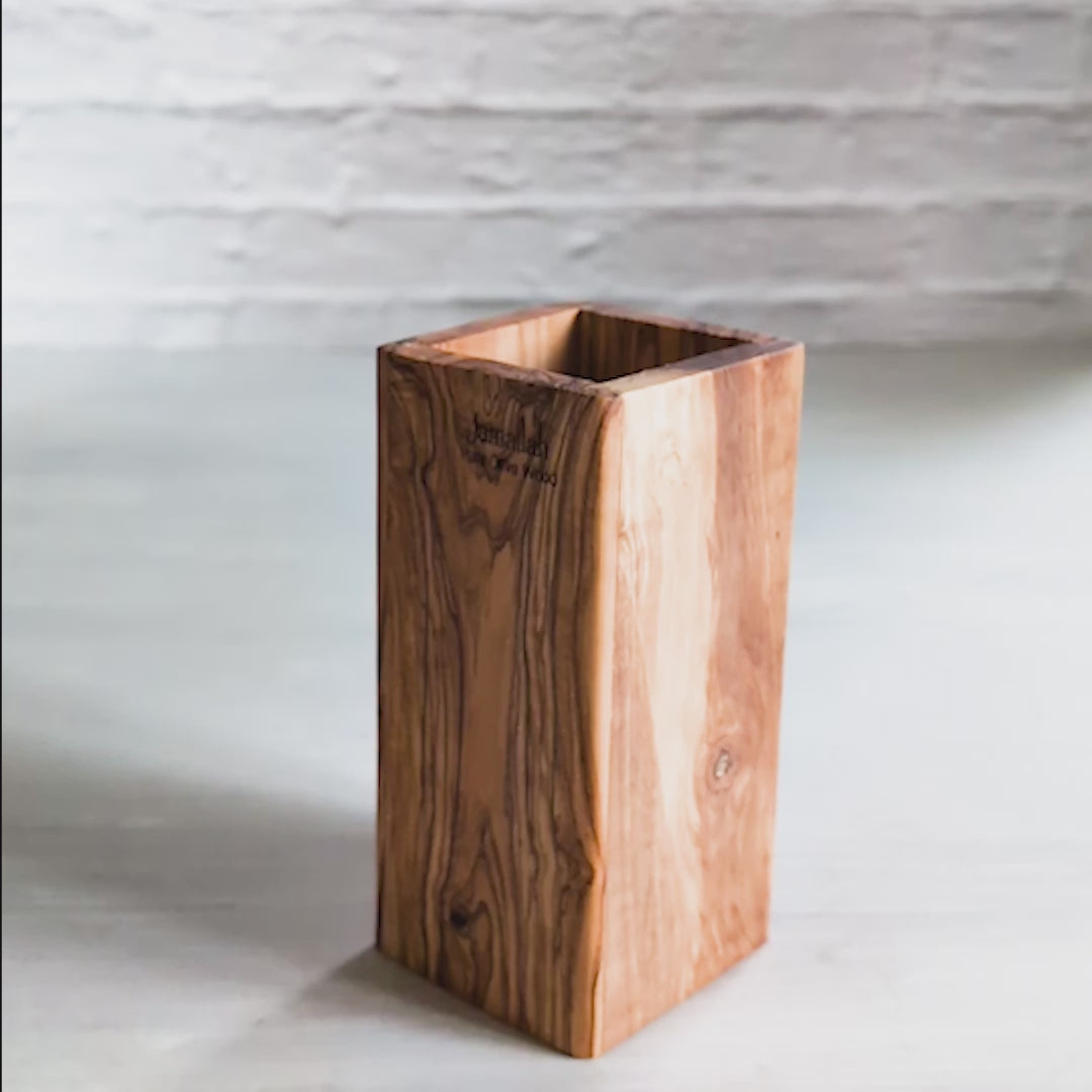 video presenting a holder for kitchen utensils made from olive wood